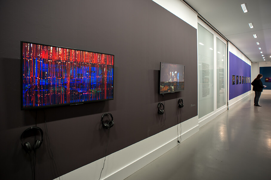 Ansicht der Ausstellung "Chez Icke" mit zwei Monitoren, die Kneipenimpressionen abspielen